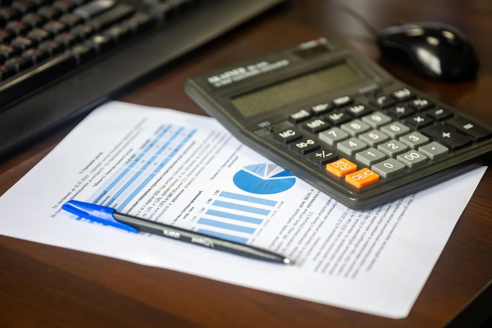 Home model, calculator, and financial documentation representing bridging loan calculations