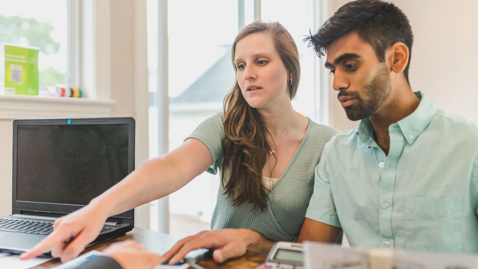 Couple consulting with a home loan adviser in an office