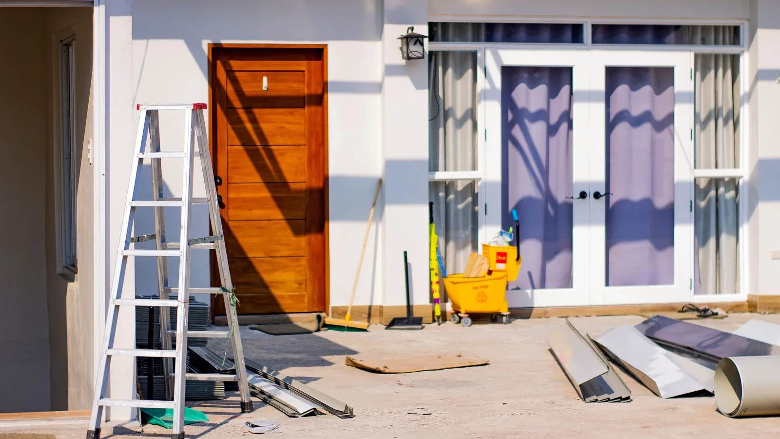 Home renovation scene with paint supplies and tools, showing a room being upgraded