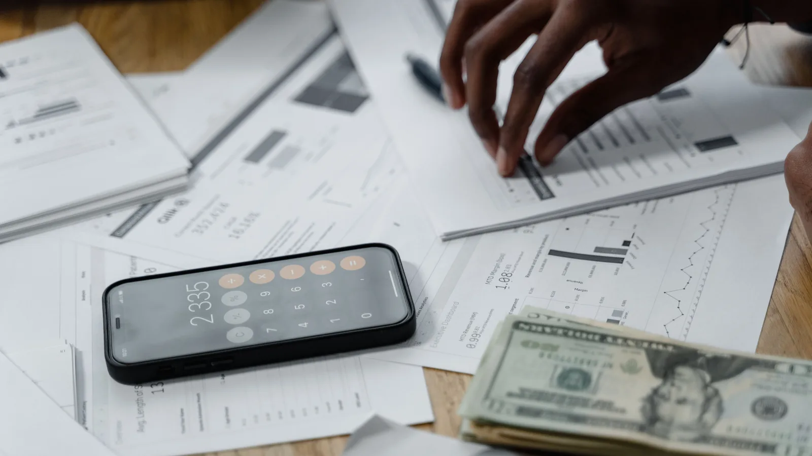 Payslips, bank statements, and financial documents laid out on a desk