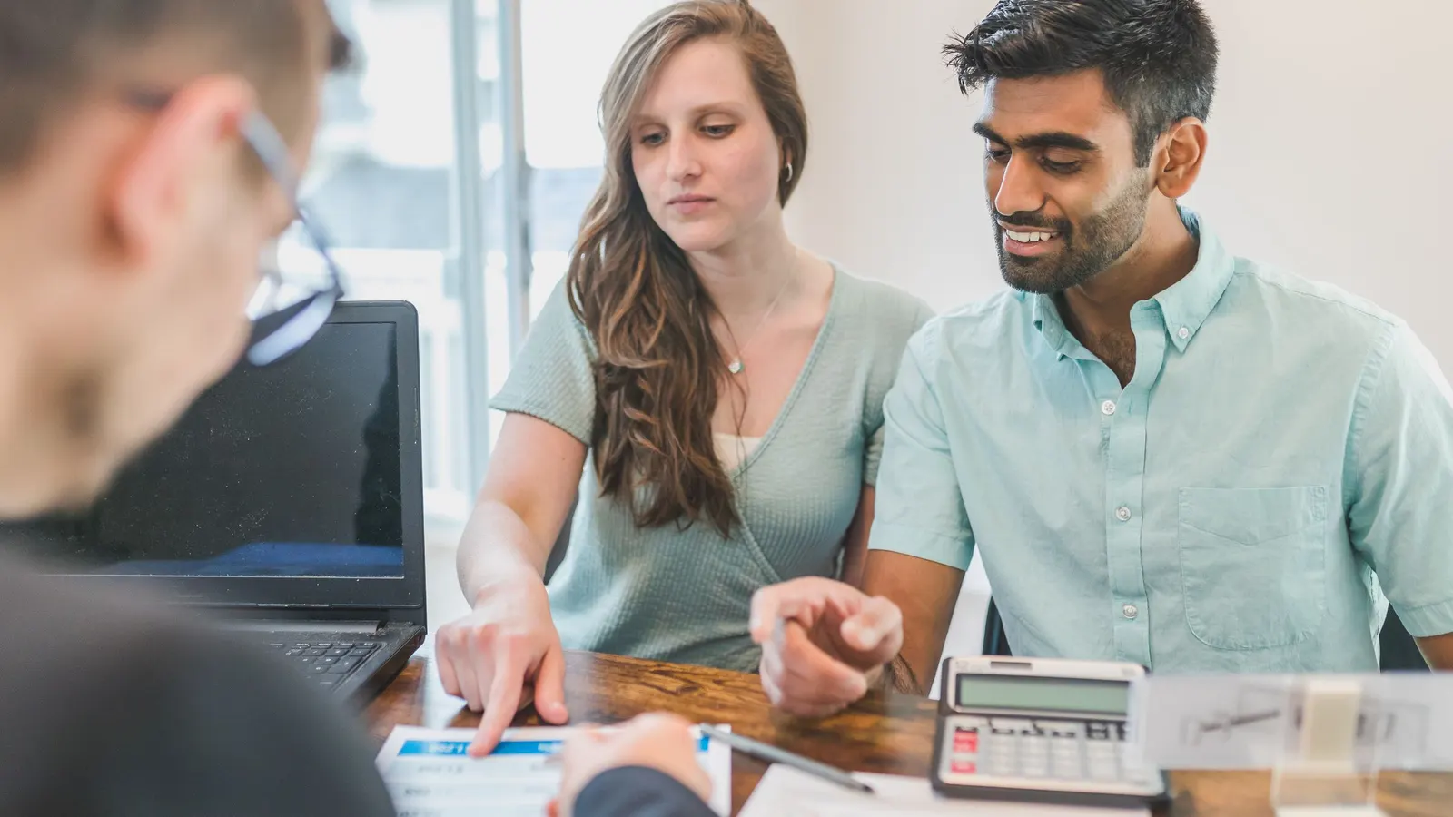 Couple meeting with a home loan adviser to go through their borrowing options