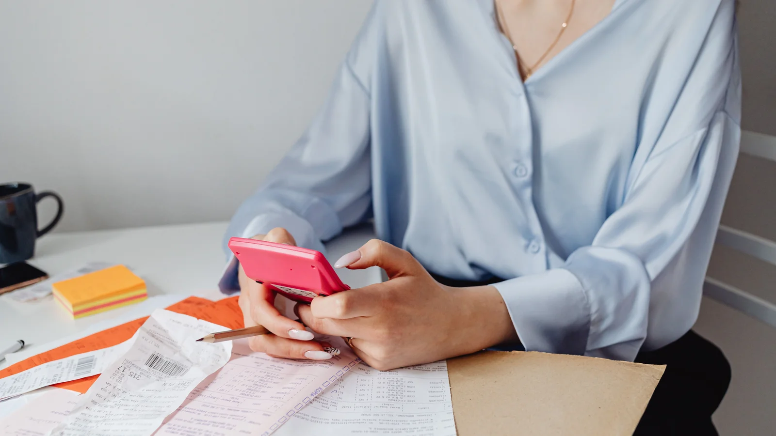 Financial documents, notebook, and calculator on a desk for budgeting home loan deposit