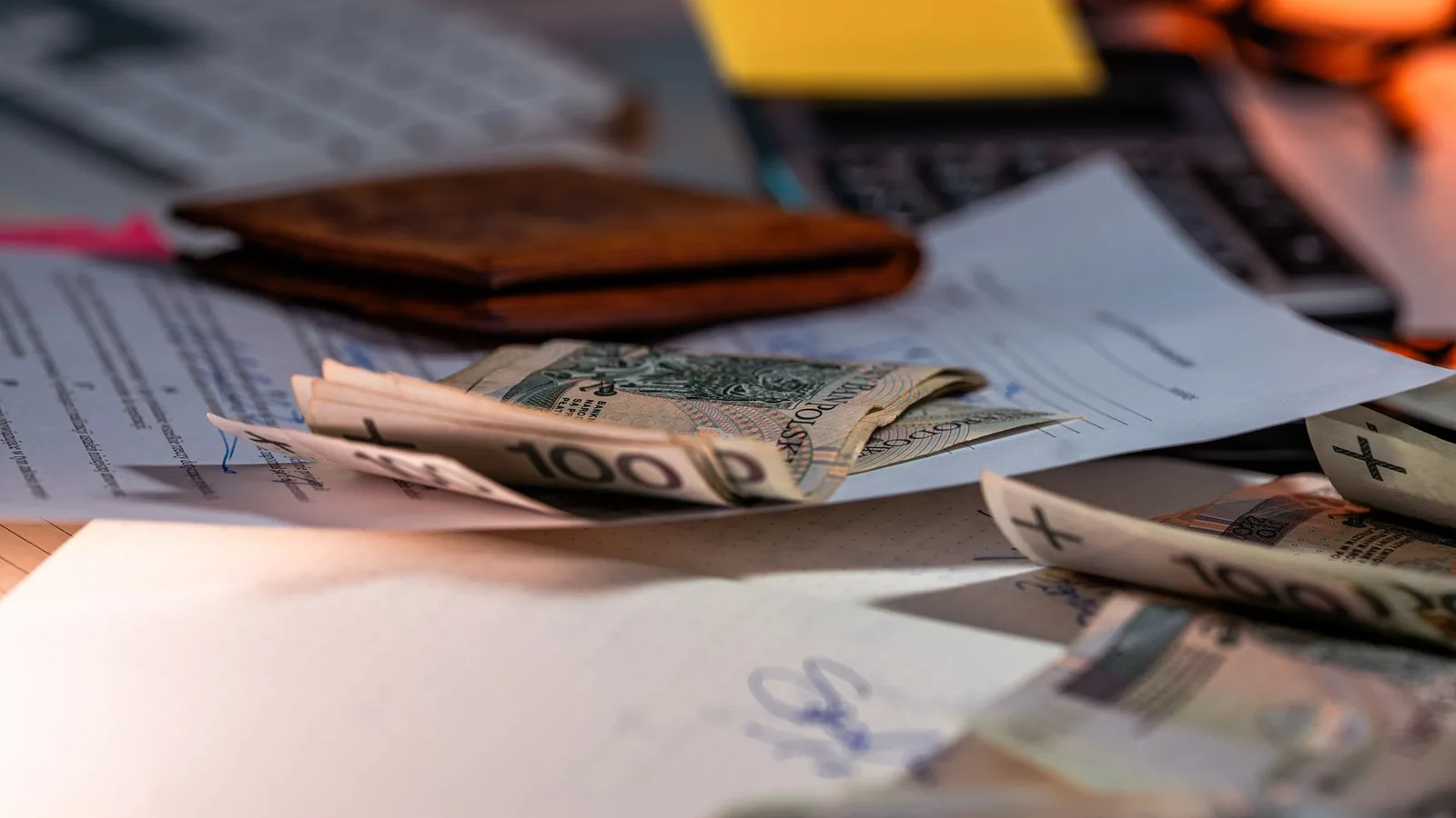 Financial paperwork and mortgage calculator showing interest rate calculations and budget numbers