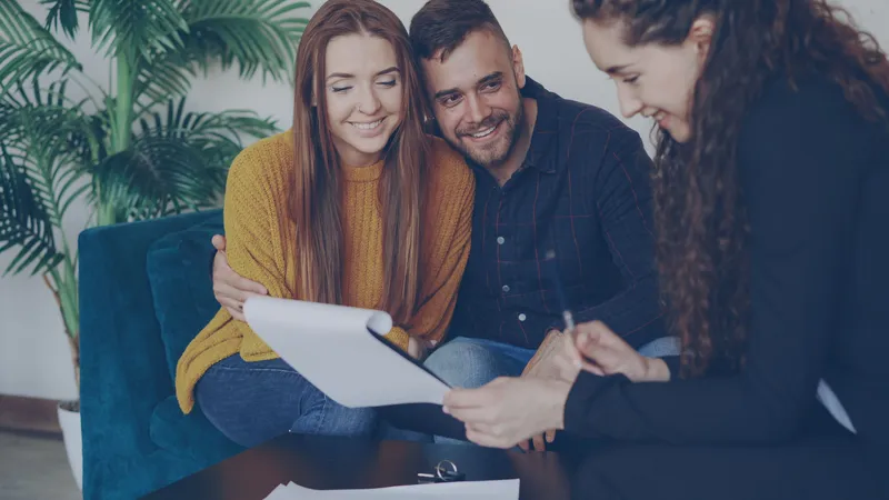 Couple meeting with a home loan adviser in an office, discussing mortgage pre-approval