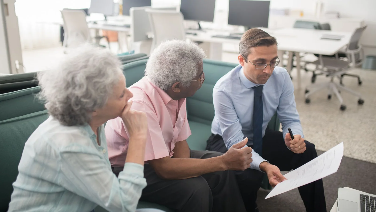 Home loan adviser meeting with a couple in an office discussing mortgage structure options