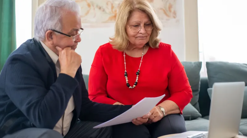 Couple reviewing their home loan repayments together on a laptop at home